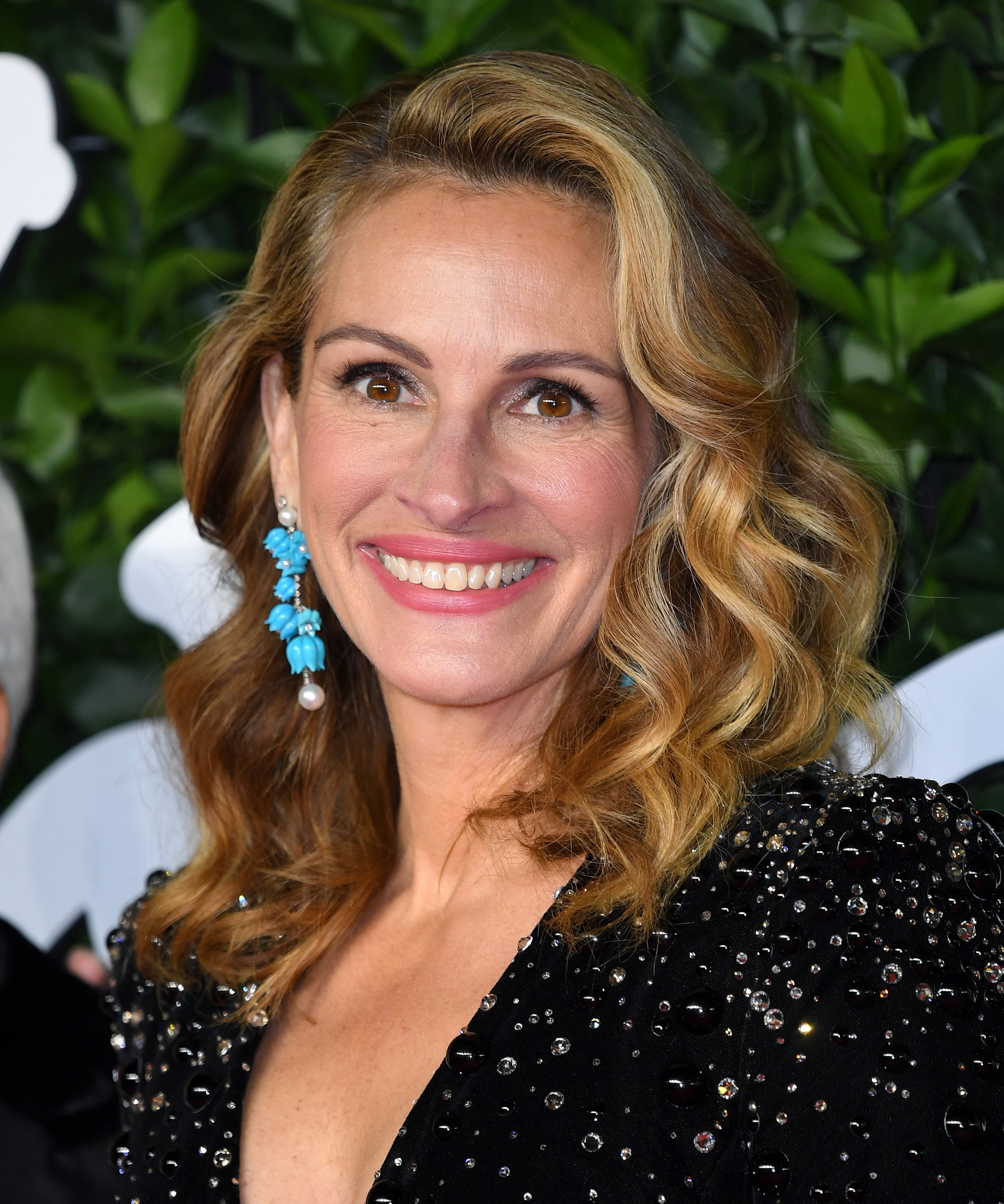 Julia Roberts debuts the biggest 80s hair we've ever seen