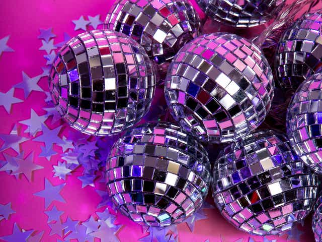 Mini disco balls and stars on a Christmas place setting.