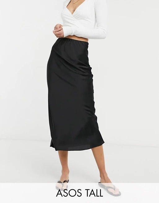 ASOS DESIGN Tall + Satin bias slip midi skirt in black