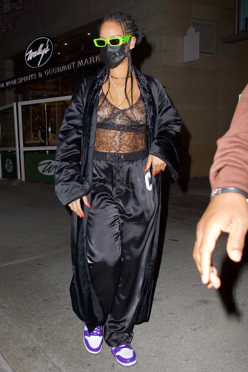 Rihanna wearing a lace camisole with a silk robe and matching pants while out to dinner at Wally's in Beverly Hills.