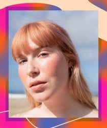 Close-up of model wearing Tower 28 Beauty blush at the beach on a designed border.