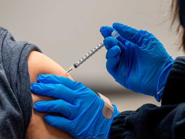 A man is inoculated with the Pfizer-BioNTech Covid-19 vaccine.