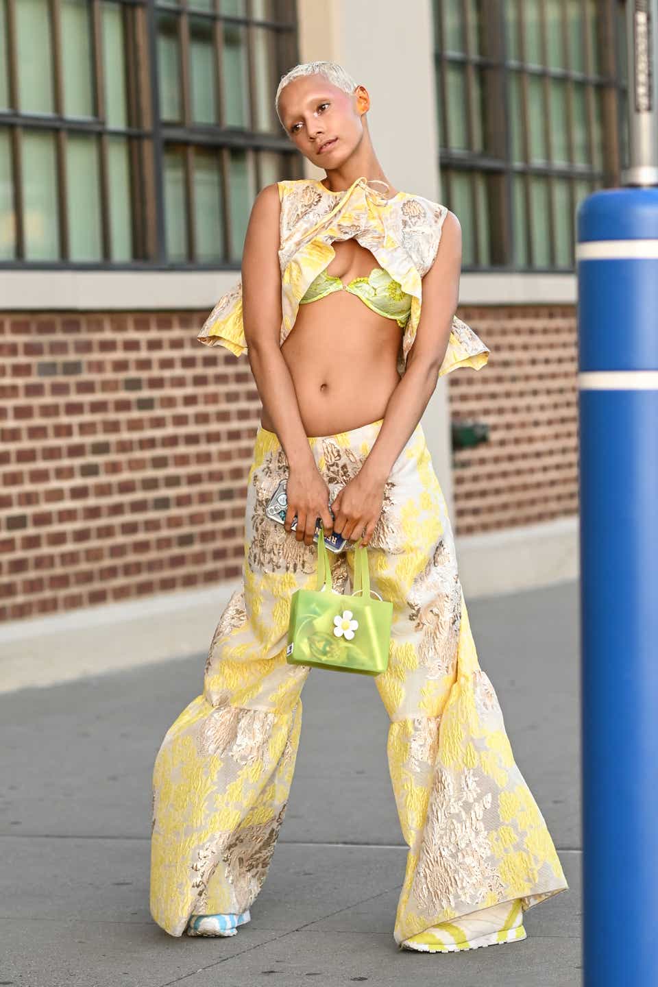 A model is seen wearing Collina Strada yellow outfit outside the Collina Strada show