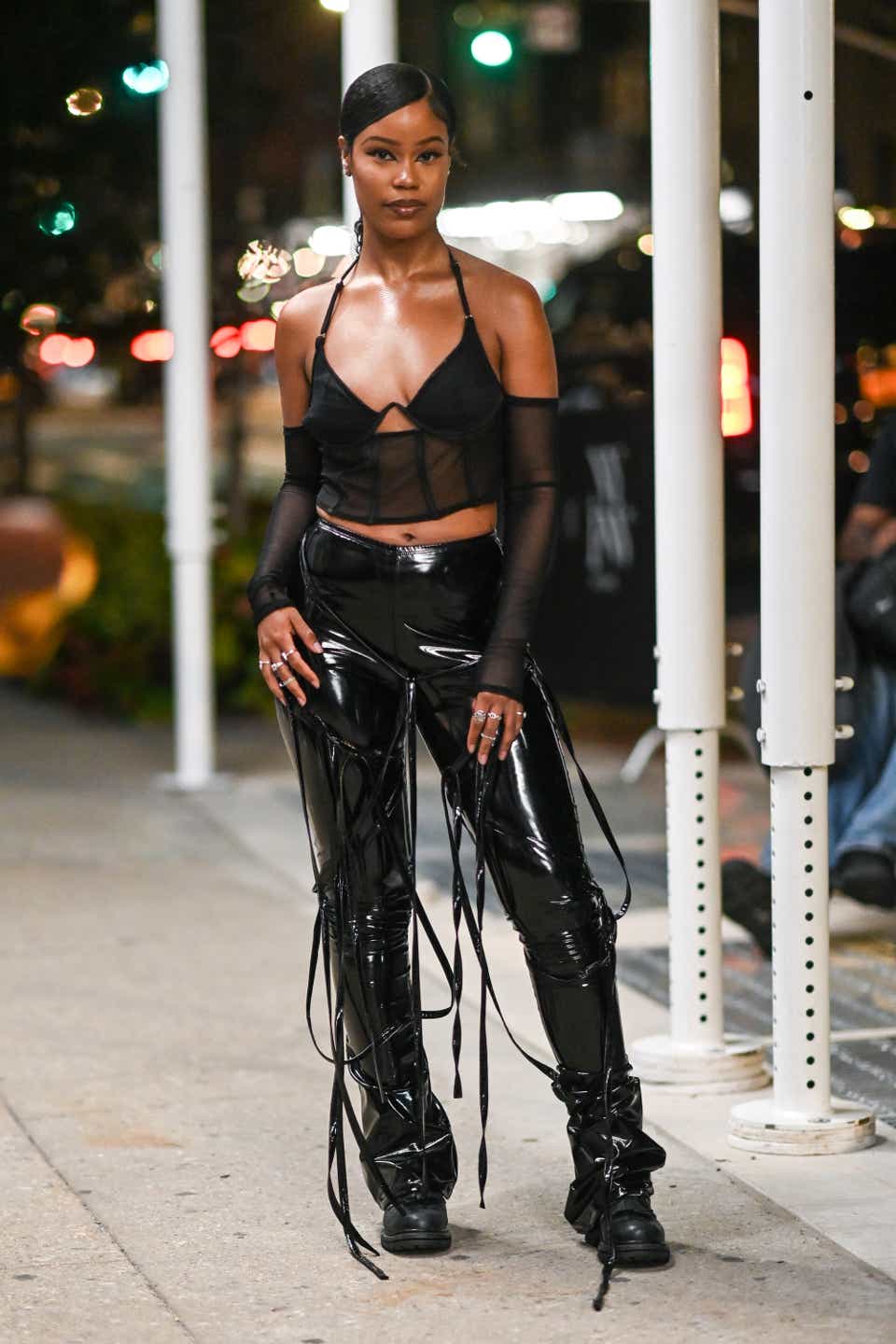 A guest is seen wearing a black bralette and black spandex outside the Staud show 