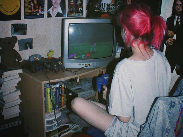 Girl playing N64 on old TV