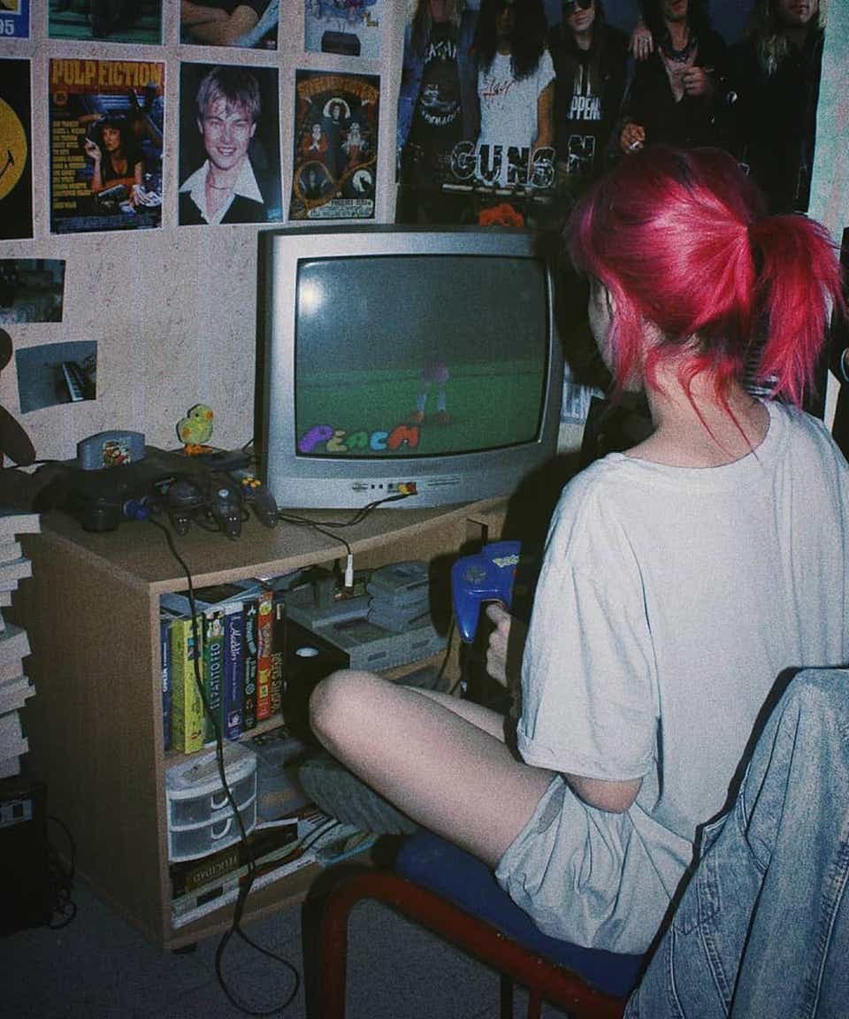 Girl playing N64 on old TV