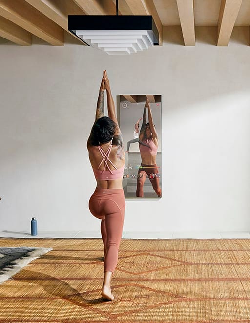 Woman doing yoga in front of the Mirror Black Friday deals 