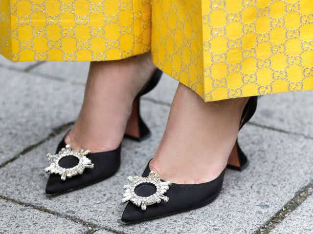 MUNICH, GERMANY - MARCH 03: Black pumps with silver crystal detail by Amina Muaddi as a detail of german TV and radio host Verena Kerth during a street style shooting on March 3, 2021 in Munich, Germany. (Photo by Streetstyleshooters/Getty Images)