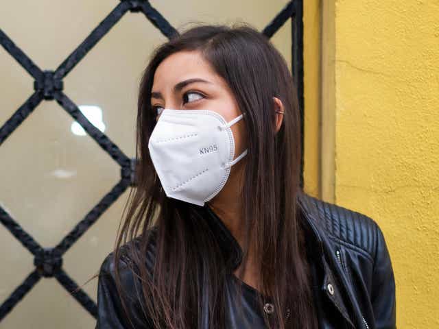 Young Hispanic woman wearing a face mask and looking away in Mexico City