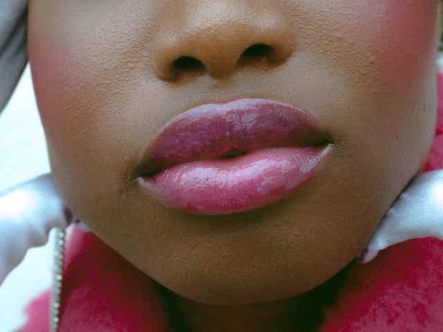 Close up of a woman with glossy pink lips