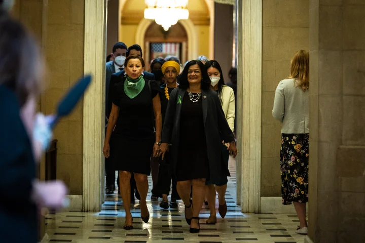 congresswoman nydia velazquez alongside congresswoman rashida tlaib walk the halls of the United States Congress with Velazquez wearing a green scarf
