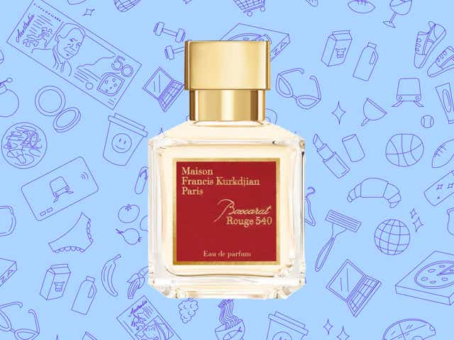 A bottle of Maison Francis Kurkdjian perfume. The bottle is red and gold.