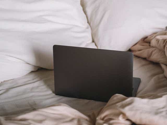 A laptop on the bed.