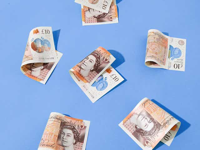 Several £10 notes photographed against a blue background