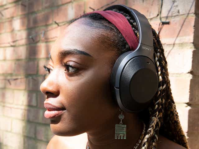 A Black girl with headphones on.