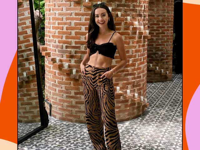 Kendall Becker wearing a black crop top with brown tiger stripe-print pants and sneakers.