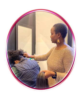 Juliet Ogbebor braids a clients hair