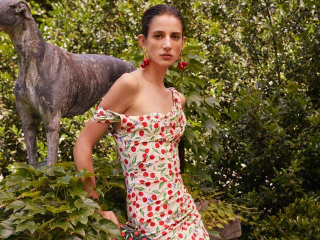 Carolina Herrera Resort 2023 model wearing a white cherry printed dress