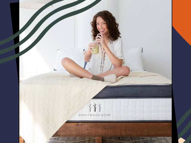 woman sitting on bed drinking smoothie