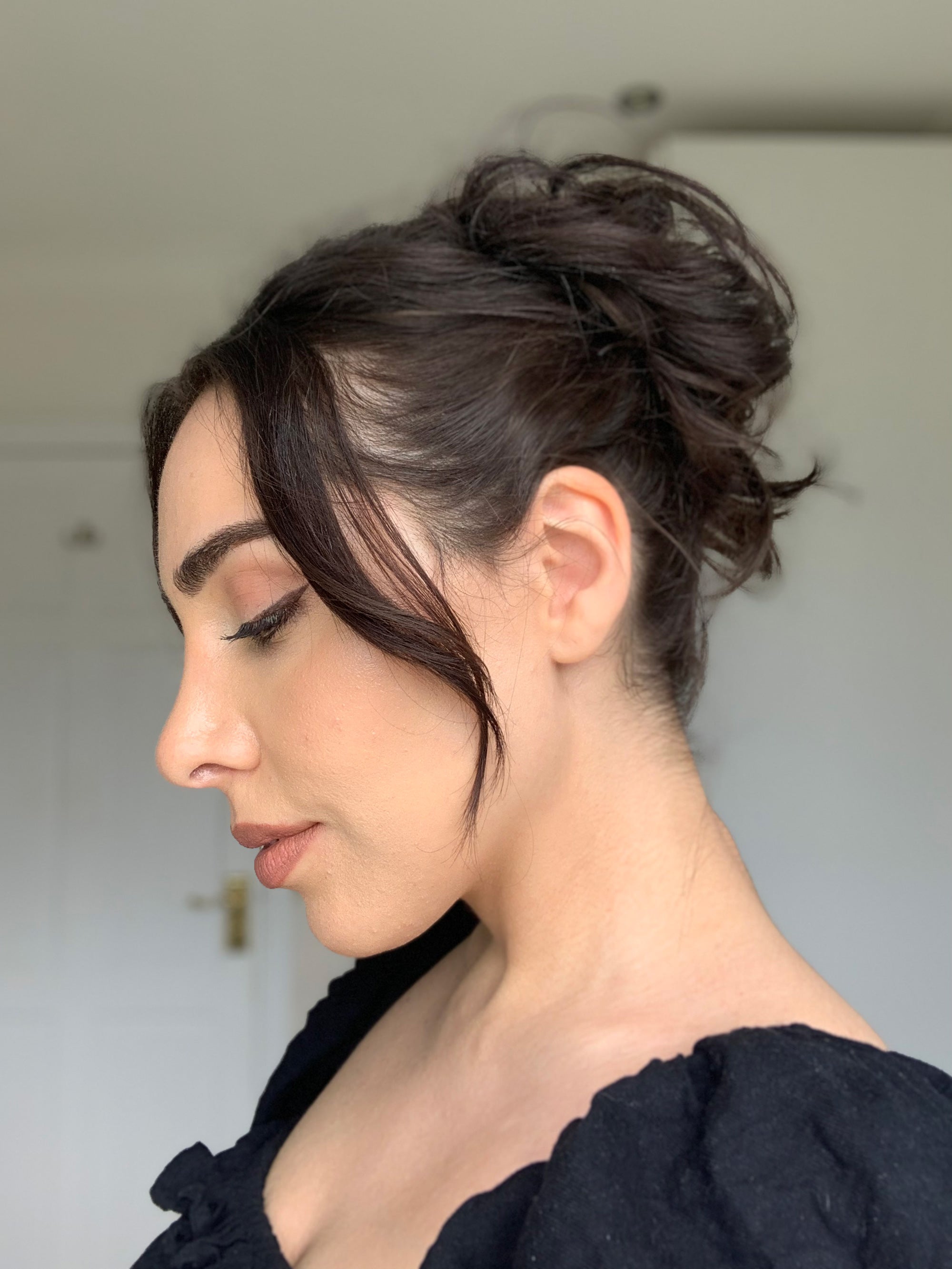 Image of Messy bun with face-framing strands for oval face