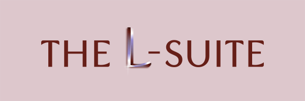 A purple and burgundy logo that says The L-Suite