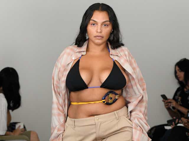 Paloma Elsesser wearing a brown bikini top with a pink gingham button-down and beige midi skirt.