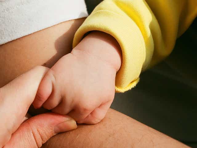 Adult holding a child's hand