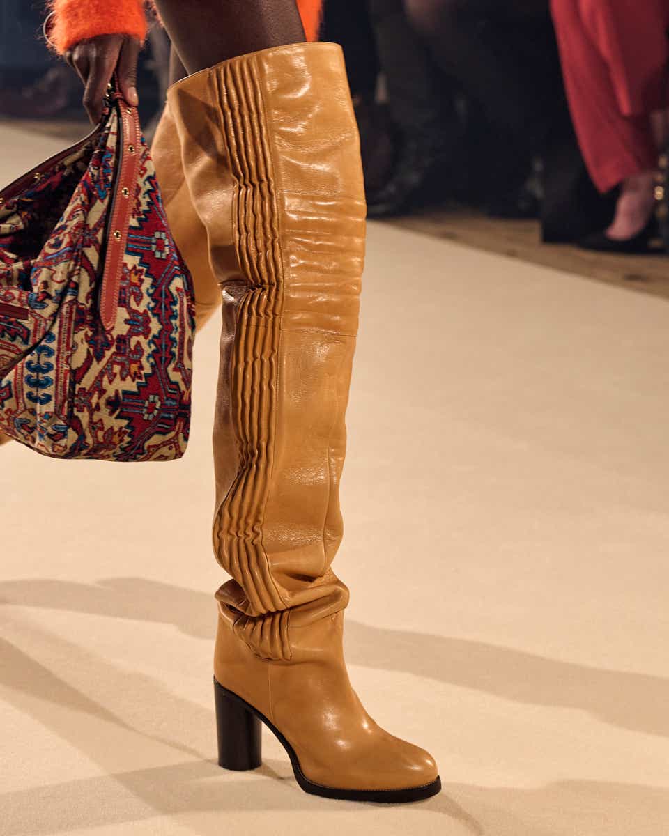 A model wearing an over-the-knee brown boot on the runway of Isabel Marant.