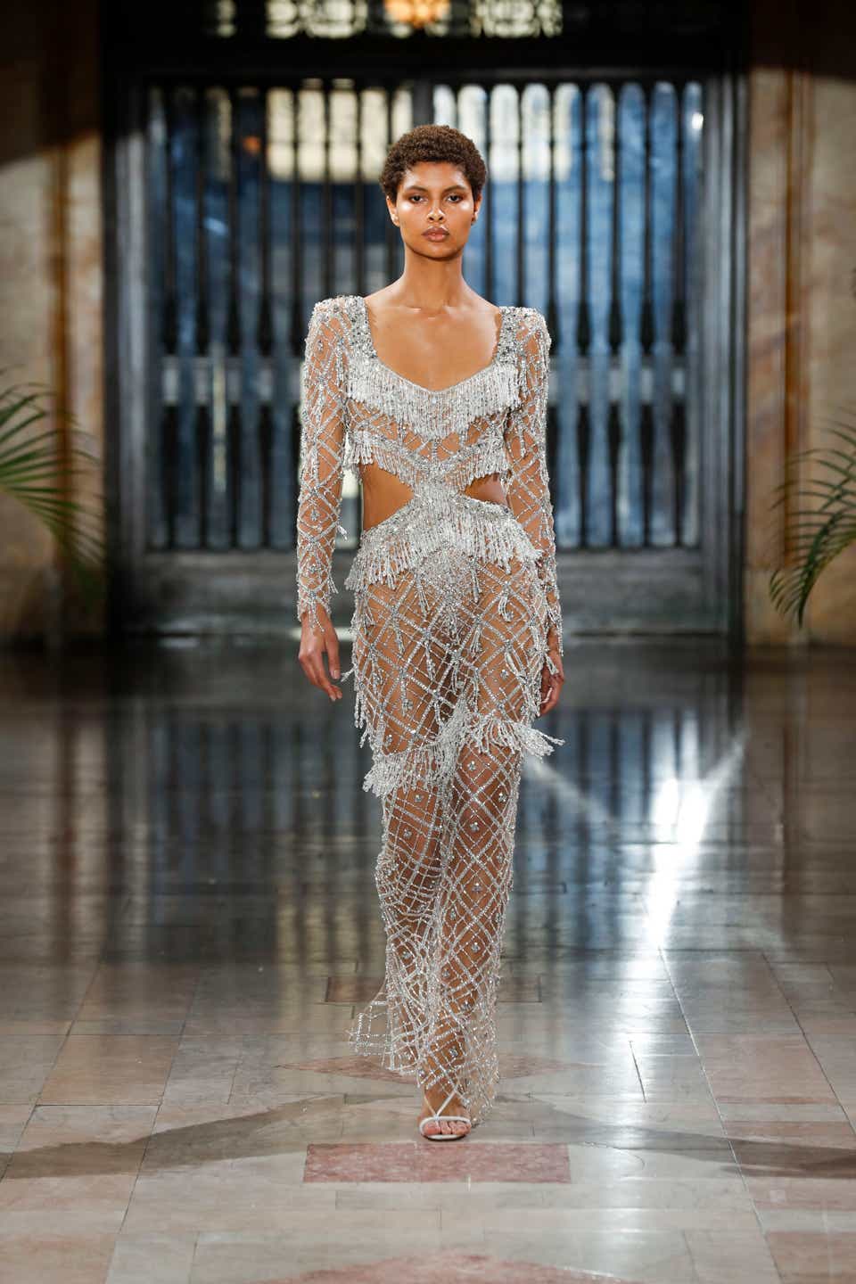 A model wearing a crystal-embellished gown on the runway of PatBo.