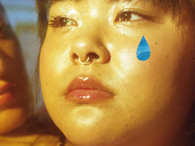 Woman crying with a superimposed tear on her face