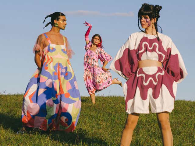 a group of people stand on grass wearing clothes by amanda forastieri