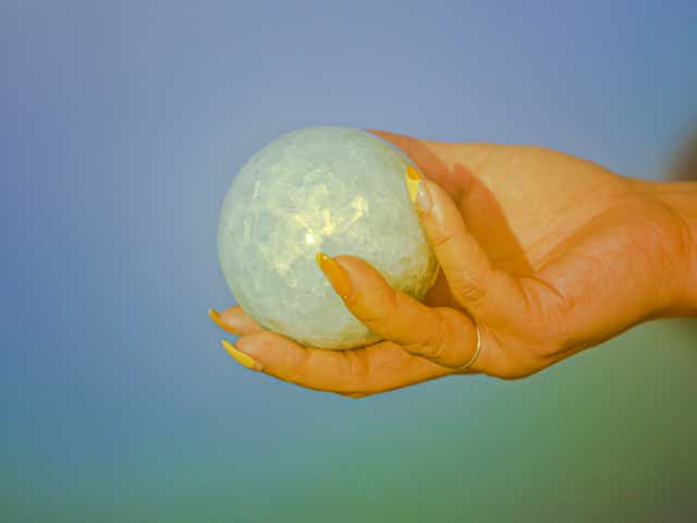 Manifestation: Person holding a crystal ball.