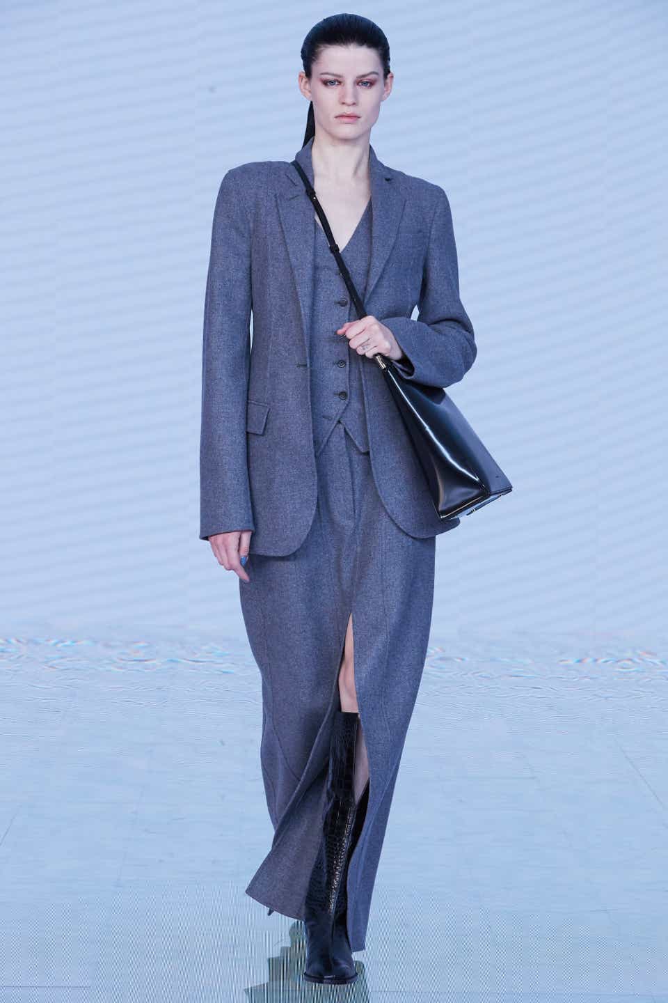 A model wearing a gray skirt suit on the Peter Do Fall 2022 runway.