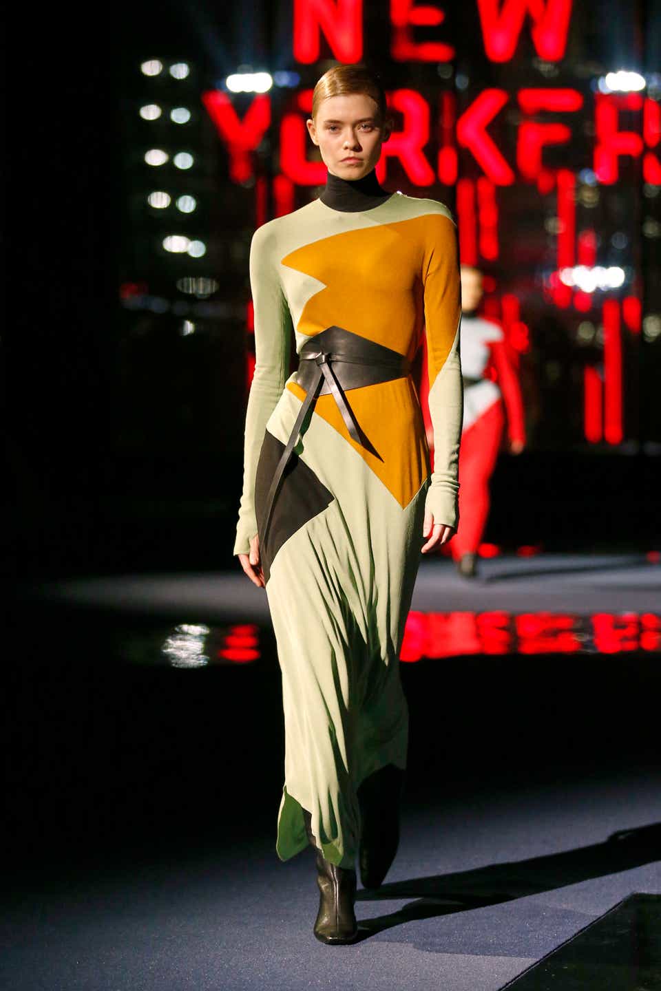 A model wearing a graphic maxi dress on the Tory Burch Fall 2022 runway.