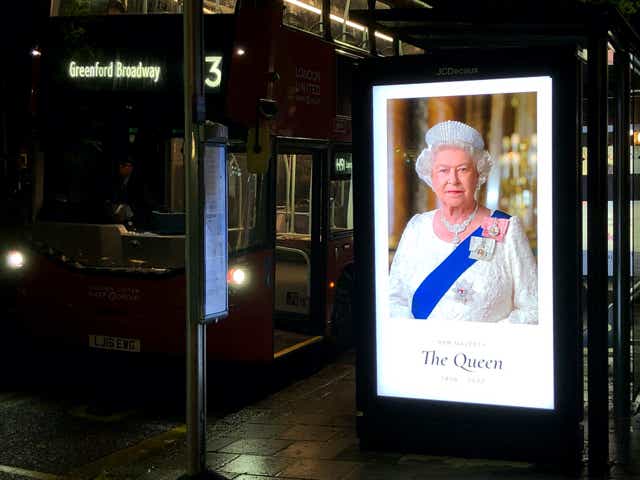A neon sign at a bus stop on Chiswick High Road shows a photograph of Queen Elizabeth II with the dates 1926-2022. Britain's Queen Elizabeth II is dead. She died Thursday at the age of 96 at her country estate Balmoral Castle in Scotland.