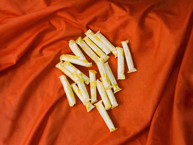 Tampons photographed against a red backdrop