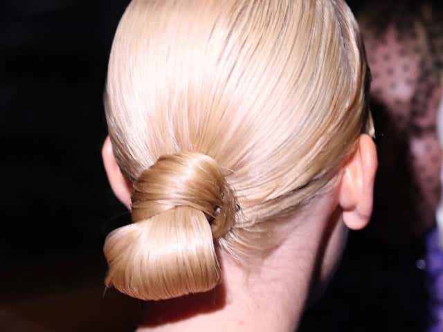 Model photographed from behind wearing a loop bun