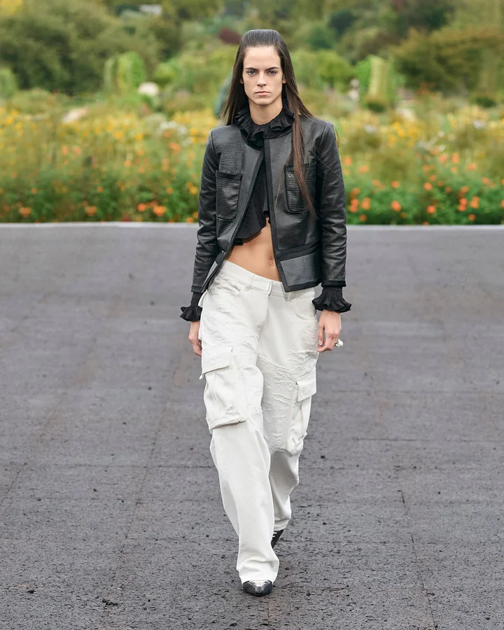 A model wearing white cargo pants on the Givenchy Spring 2023 runway.