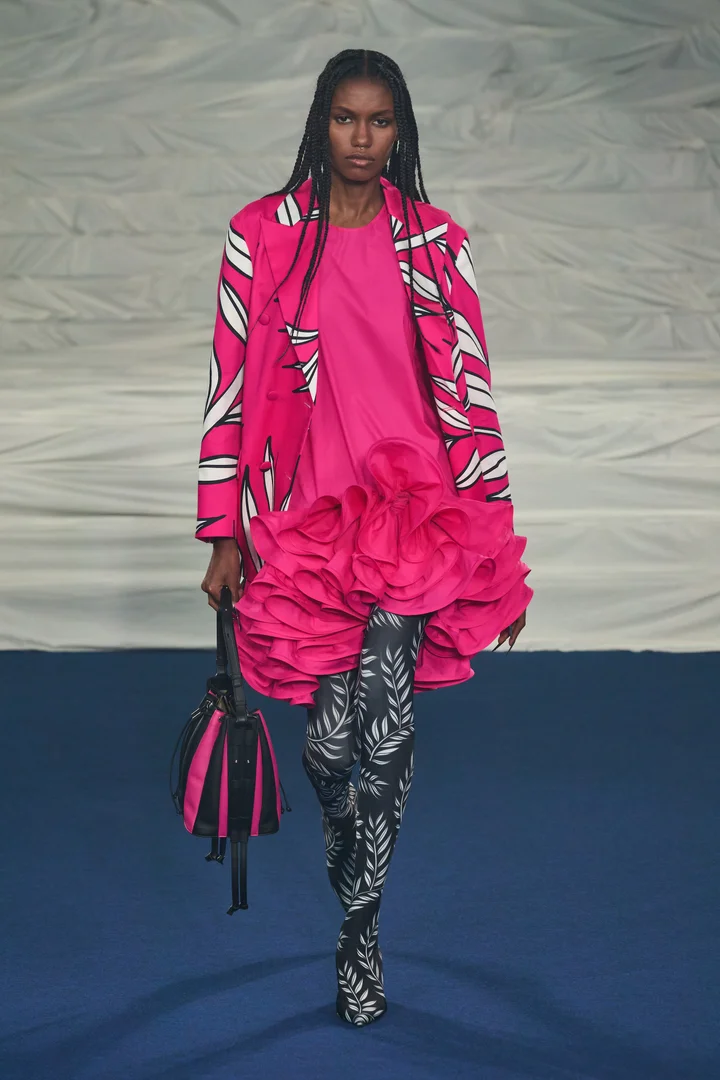 A model wearing a ruffled pink dress on the Rochas Spring 2023 runway.