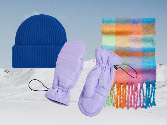 Blue ribbed hat, multicoloured scarf and purple puffer mittens against an image of a snowy mountain