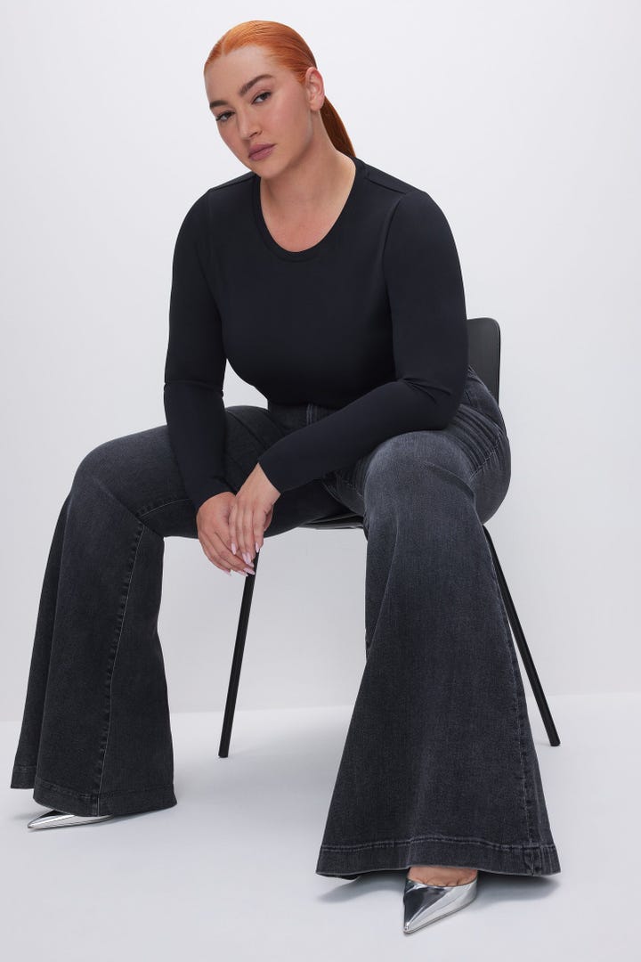 A model wearing Good American flare jeans