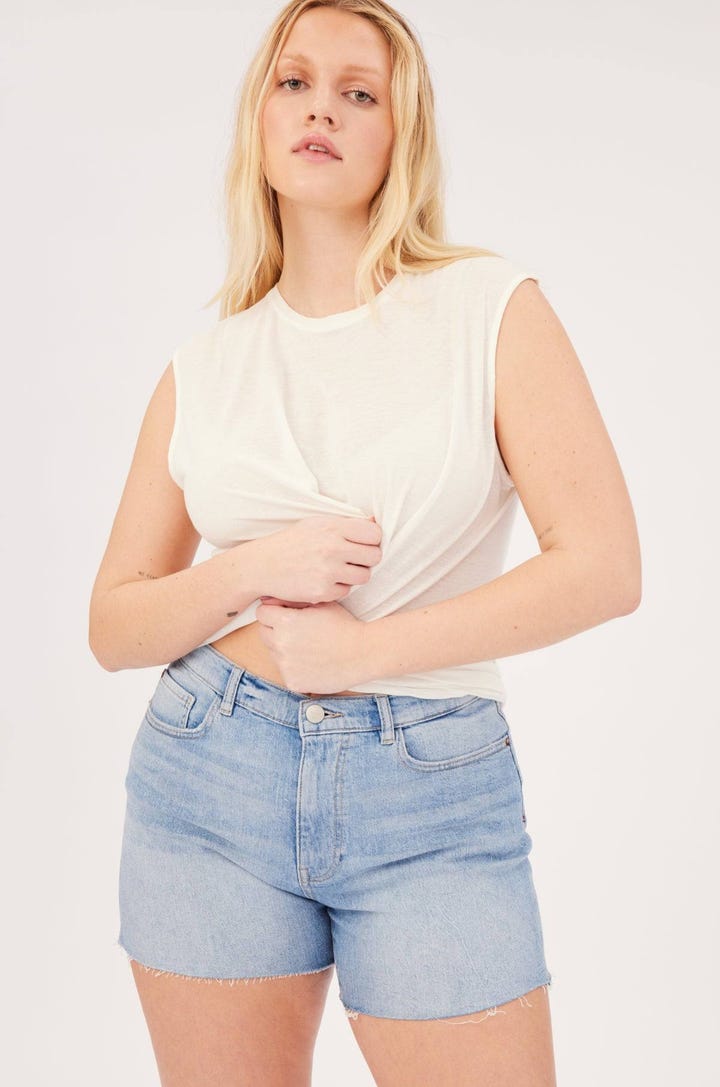 A model wearing Warp + Weft denim shorts