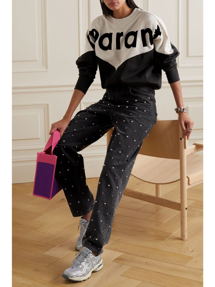 A model wearing faux-pearl-embellished black jeans from Marant Etoile