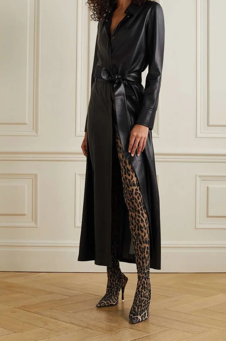 Model in leopard print tights and black leather coat