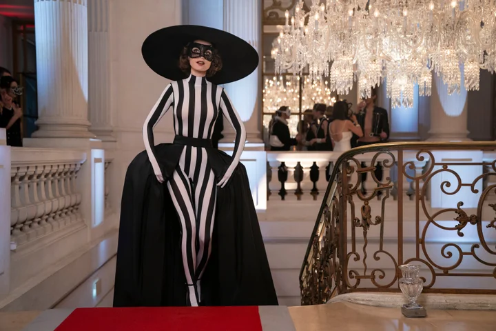 Lily Collins as Emily Cooper in Emily Paris Season 4, wearing a black and white striped masquerade gown