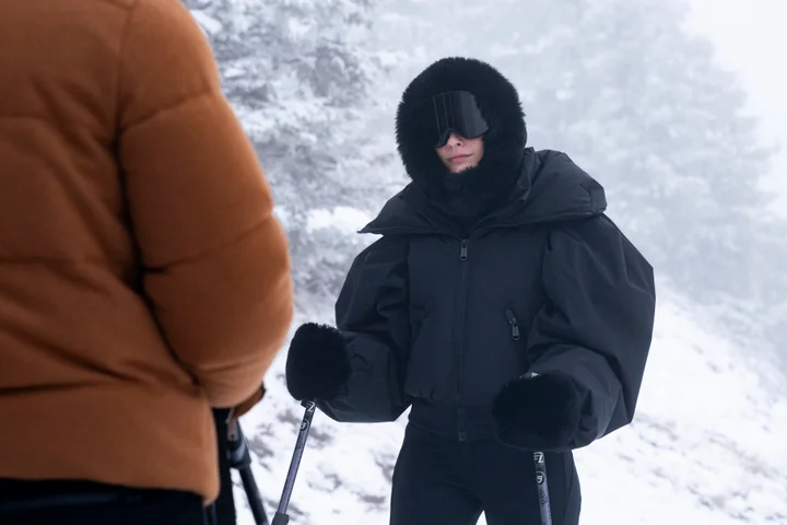 Camille Razat as Camille in Emily Paris season 4 wearing a dark ski outfit