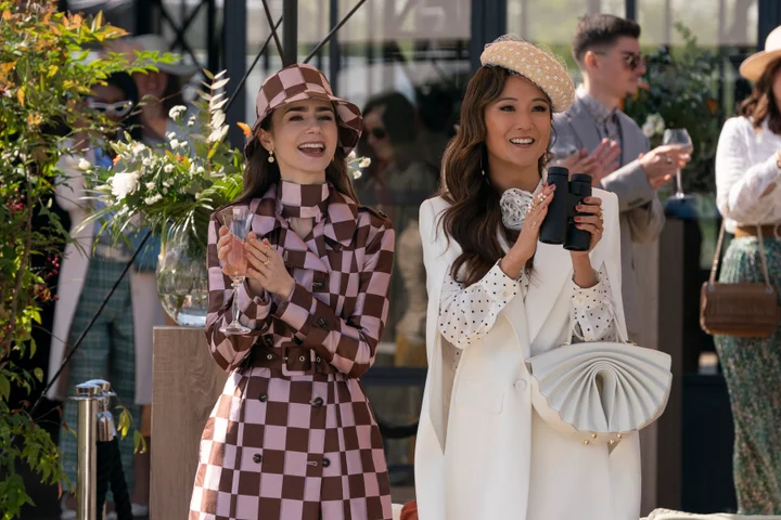 Lily Collins and Ashley Park as Emily and Mindy in Emily in Paris season 4 wearing polo outfits