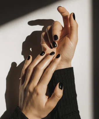 Hands with black gel polish