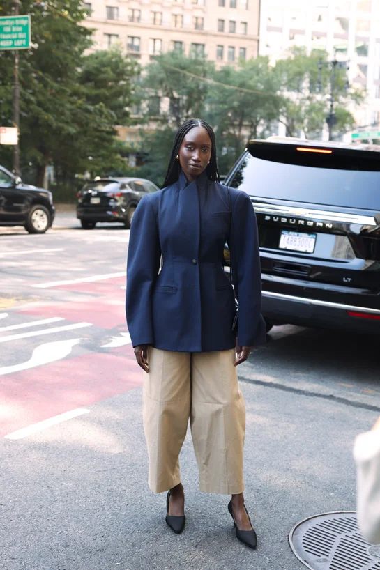 NYFW attendee wearing high collar jacket and barrel pants