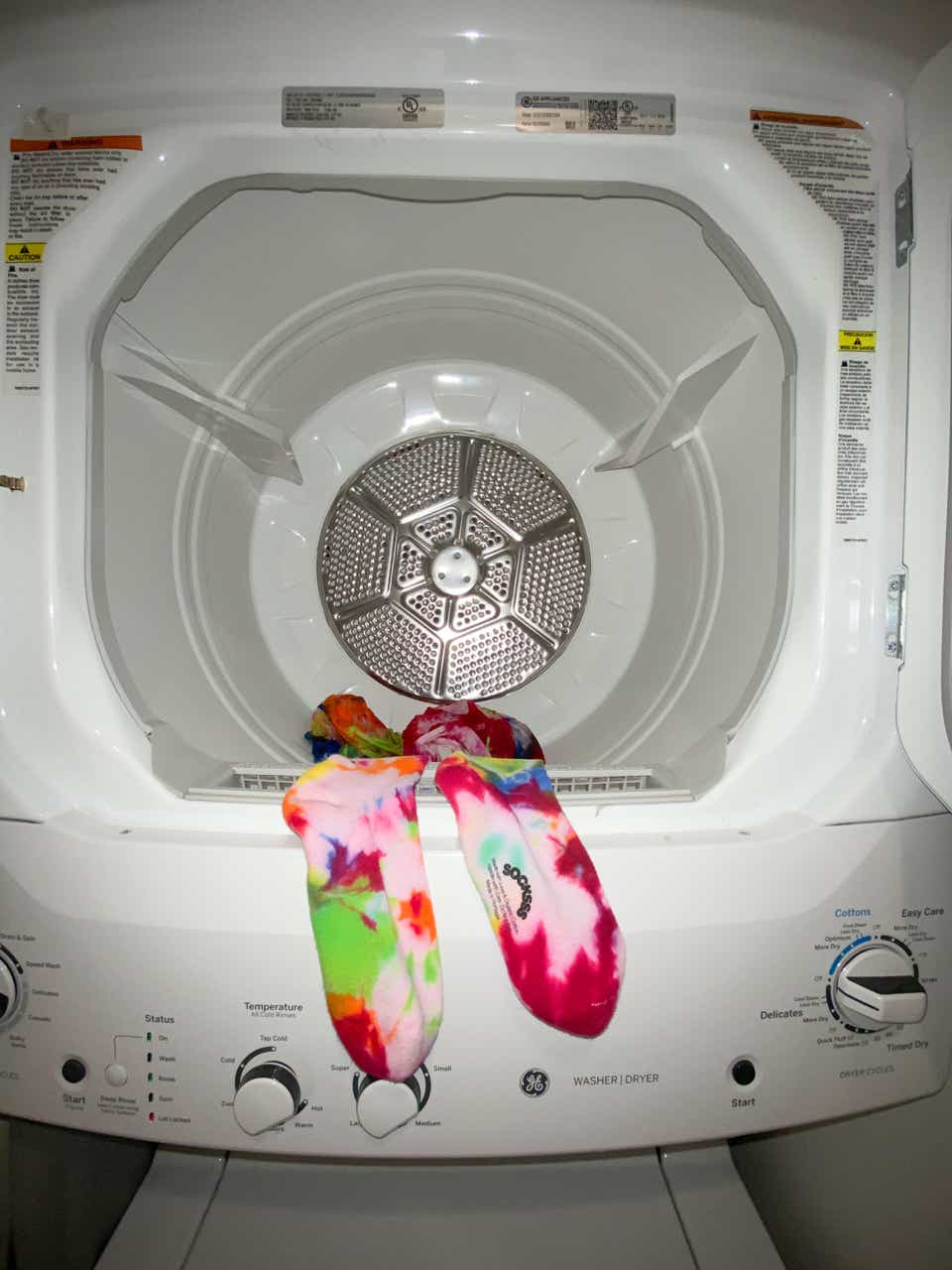 Photo of tie-dyed socks in an empty machine washer.